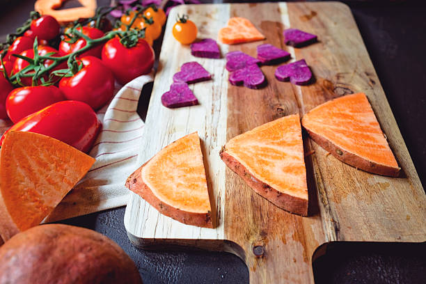 Yellow and orange fruits and vegetables on a wooden board